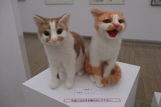 Illustration for article titled You Can Wear This Freaky Cat Head in Tokyo